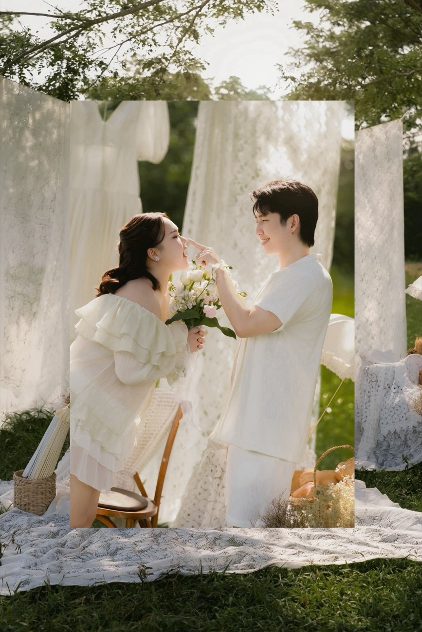 Couple beneath a draped white frame in the garden