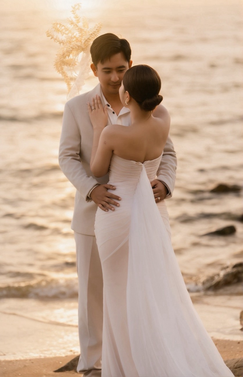 Couple embracing by the sea at sunset